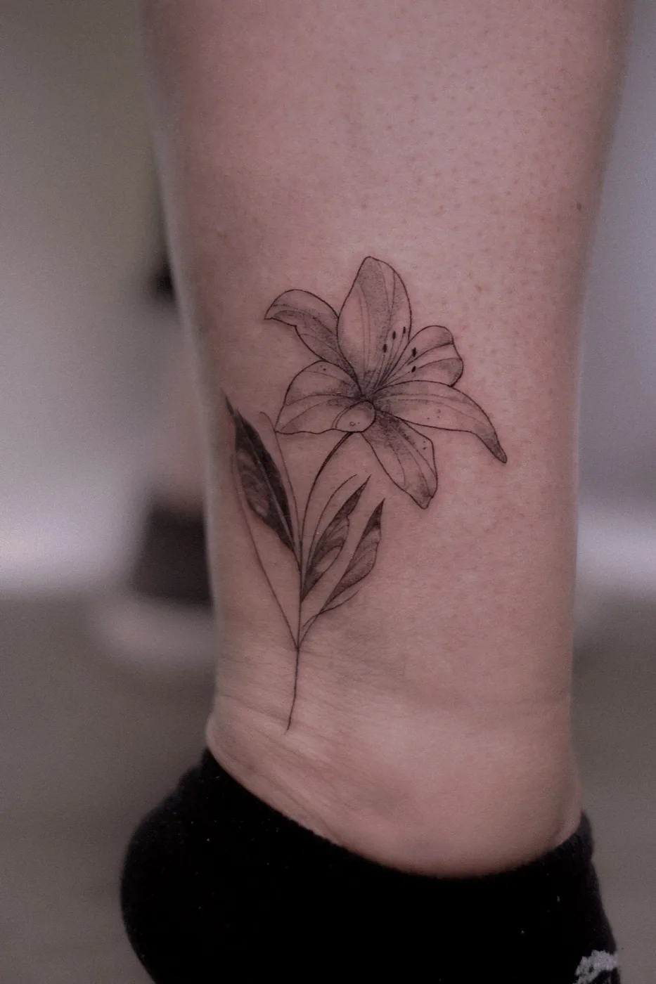 Fine-line lily on ankle