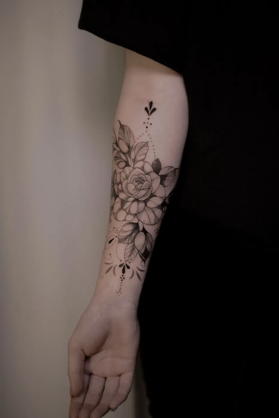 Rose with dotwork ornament on forearm