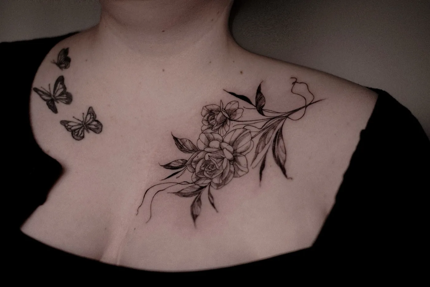 Roses and butterflies across collarbone